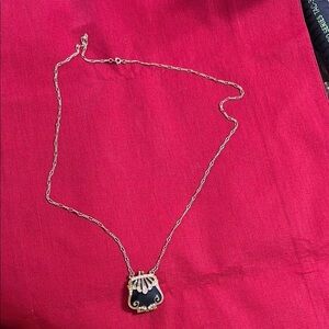 Vintage world. Large gold tone purse shape locket on long gold tone chain.